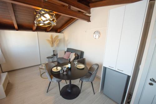 a dining room with a table and chairs at Angel's Loft! in Agios Rokkos