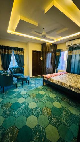 a hotel room with a bed and a couch at Rahat villas apartment in Islamabad