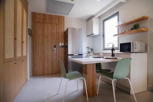 a kitchen with a table and chairs and a refrigerator at Bomo Suites in Antalya