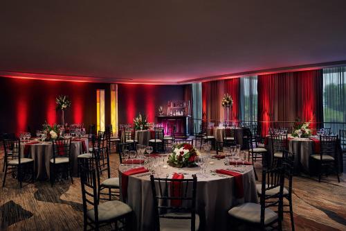 a ballroom with tables and chairs and red walls at Chicago Marriott Oak Brook in Oak Brook