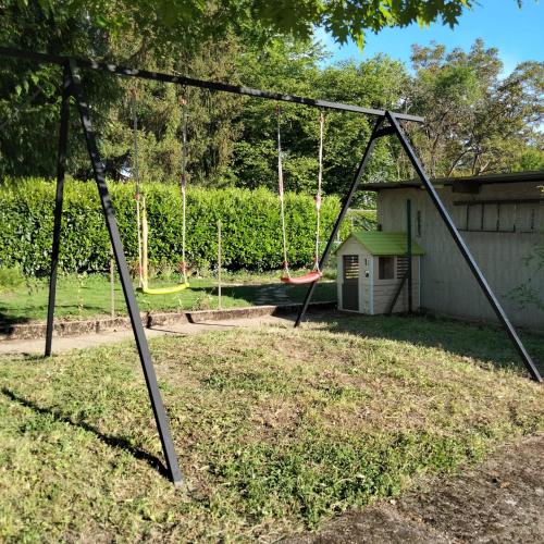a swing set in a yard with a playground at le jack in Mont-sous-Vaudrey