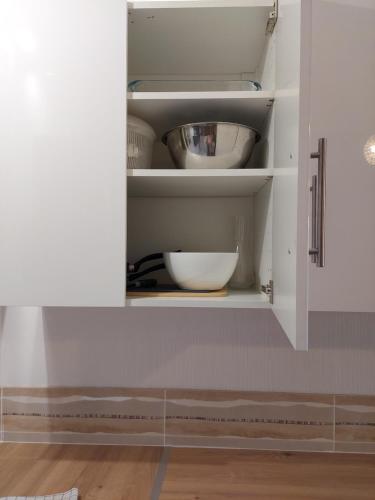 a kitchen cupboard with a bowl in it at Les Meublés des Pierres Dorées - Gite de charme pour groupe in Theizé