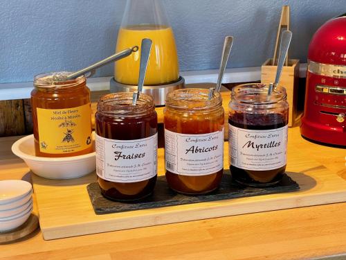 three jars of honey sitting on a shelf at Hôtel Chalet Le Panoramique in Mizoën