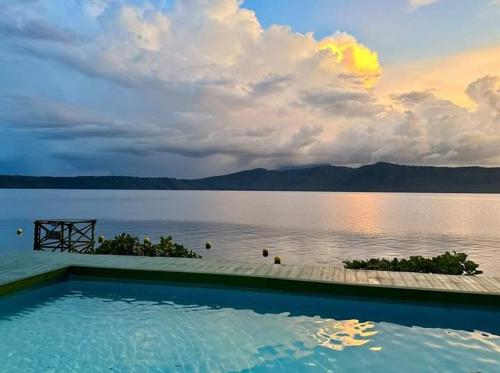 a swimming pool with a view of a body of water at Posada Ecologica La Abuela in La Laguna