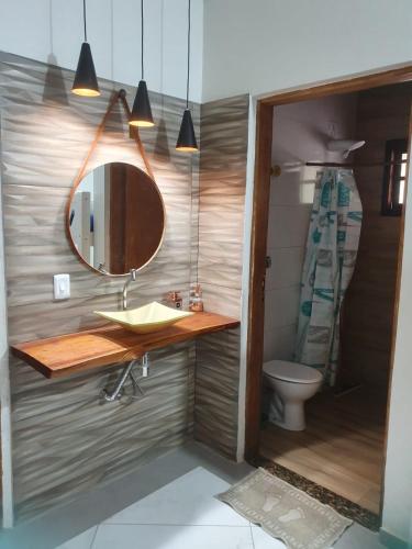 a bathroom with a sink and a mirror at Chácara Rosa Maria in São Paulo