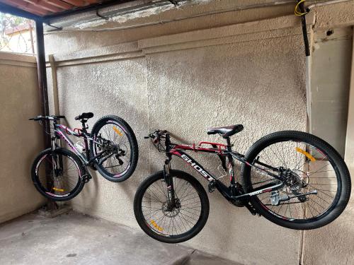 two bikes are hanging on a wall at Casa bonita y cómoda in Santa Cruz de la Sierra