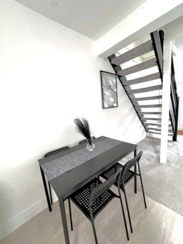 a dining room with a table and two chairs at Gillingham 4 bed Guest House in Gillingham