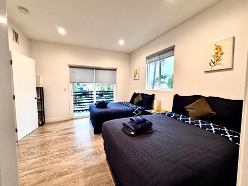 a bedroom with two beds and a living room at 4BR/4BR modern house at Mid-city in Los Angeles