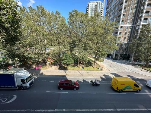 a view of a street with cars and a truck at Private Studio Flat in City 1190 in London