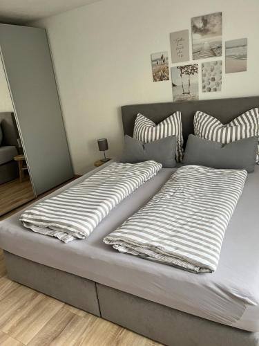 a bed with two pillows on it in a room at Ferienwohnung LINA in Bitburg