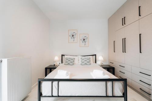 ein Schlafzimmer mit einem großen Bett und weißen Schränken in der Unterkunft Zante Luxury Apartment in Argassi