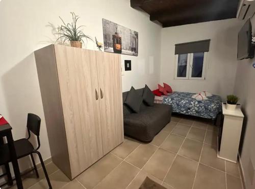 a living room with a cabinet and a bed at Mambo House in Milan