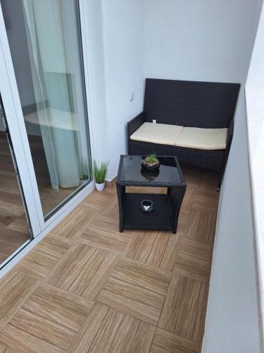 a room with a couch and a table on a floor at Sandanski park view in Sandanski