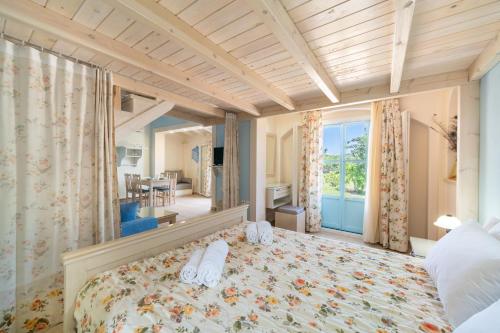 a bedroom with a bed with shoes on it at Aroggia Farm in Xanthátai