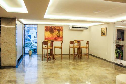 a room with chairs and a table in it at Smart Hotel João Pessoa in João Pessoa