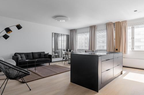 a kitchen and living room with a black and white at Lux Eight, 2-Bedroom City Centrum in Turku