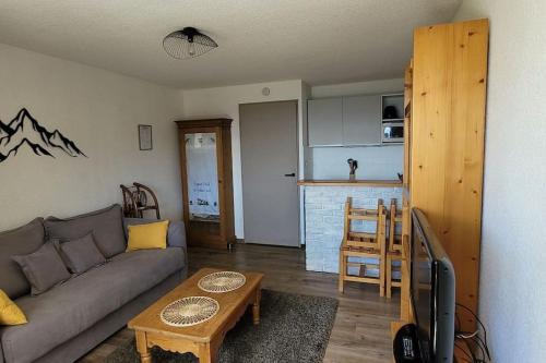 un salon avec un canapé et une table dans l'établissement Appartement 4 personnes au pied des pistes, à Saint-François-Longchamp