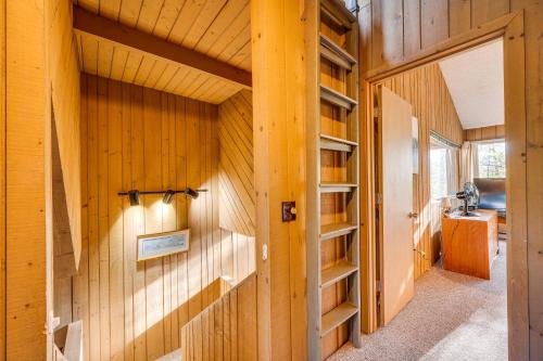 a hallway with wooden walls and shelves in a house at All-Season Conway Condo with Private Hot Tub! in North Conway