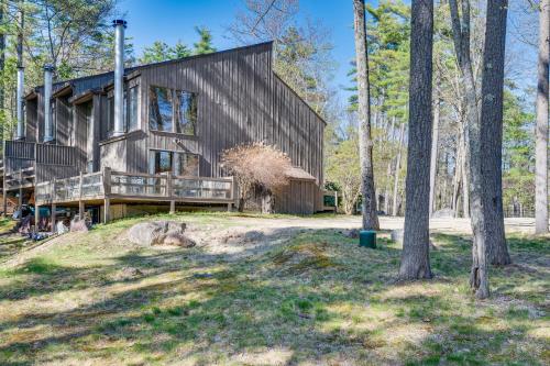 a house in the woods with a tree at 0 5 Mi to Dtwn and Trails Conway Condo with Hot Tub! in North Conway