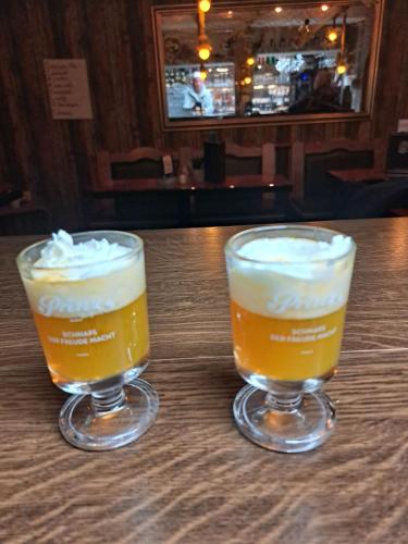two glasses of beer sitting on a table at NordseeResort Hotel & Suite Arche Noah in Horumersiel