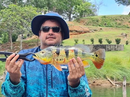 a man holding a large fish in his hands at Bungalu Fishing Lodge Panama in Colón