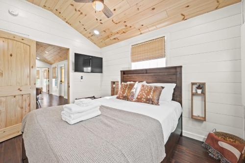 a bedroom with a large bed and a television at Block of 4 Lodges at Eden Reserve - For Groups in Williamstown