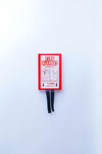 a red fire chamber sign on a white wall at Aurora Smart Residence, Wuse 2, Abuja in Abuja