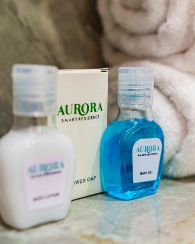 two bottles of soap sitting on a counter next to a box at Aurora Smart Residence, Wuse 2, Abuja in Abuja