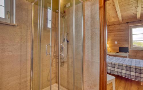 a bathroom with a shower and a bed in a room at Nice Home In Farnese With Outdoor Swimming Pool in Farnese