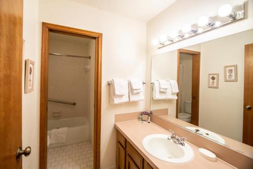 a bathroom with a sink and a mirror at Sweetwater at Lake Conroe, a VRI resort in Montgomery