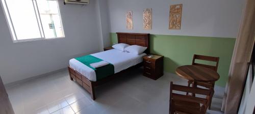 A bed or beds in a room at Amaca Suites
