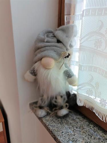 a stuffed animal sitting on a shelf next to a window at Appartamenti Viola Walter in Cavedago