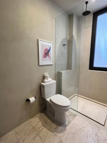 a bathroom with a toilet and a shower at Casa Azul Residences in Sayulita