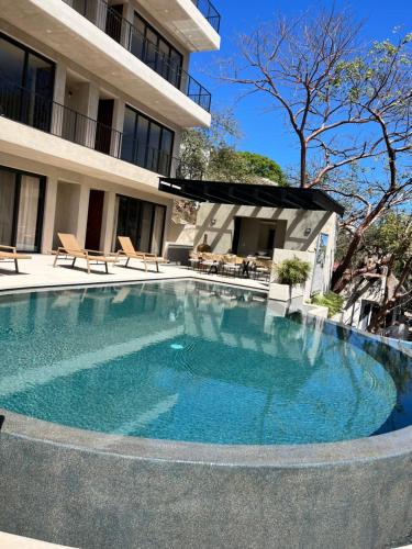 a large swimming pool in front of a building at Casa Azul Residences in Sayulita