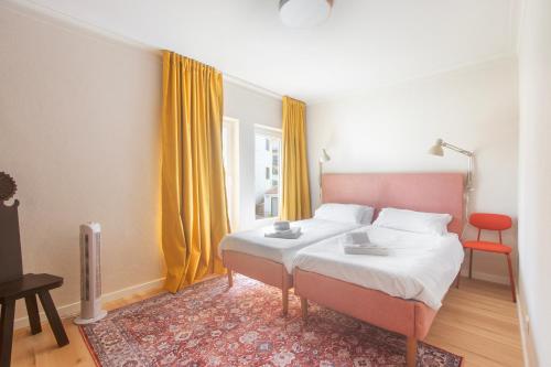 a bedroom with a bed and a red chair at Retreat Villa, Full Amenities, up to 40ppl in Lisbon