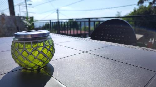 a green glass jar sitting on top of a table at Casa rural completa y con garaje in Vigo