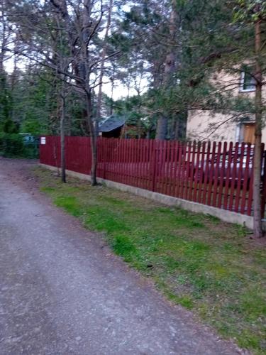 a red fence on the side of a road at Domimat-Lila in Dębki