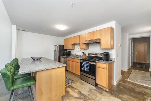 a kitchen with wooden cabinets and a stove top oven at The Coolest Loft in the Cincinnati Area in Maineville