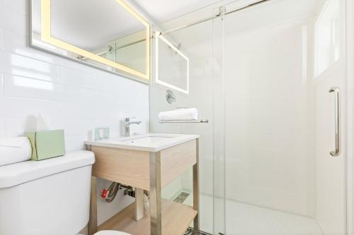 a bathroom with a sink and a shower at Tropicana Motel Wildwood Beach & Boardwalk in Wildwood