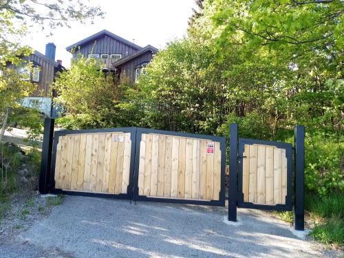 a wooden gate in front of a house at La Casa Marrone Norway in Asker