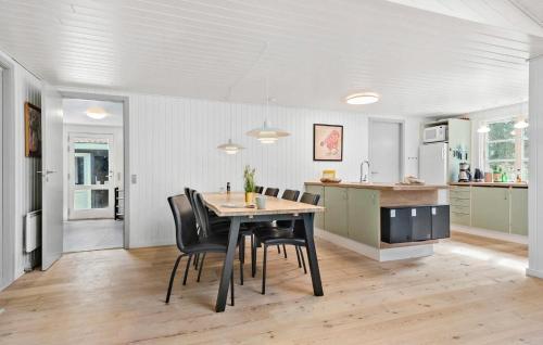 a kitchen and dining room with a table and chairs at Gorgeous Home In Ans By With Wifi in Roe
