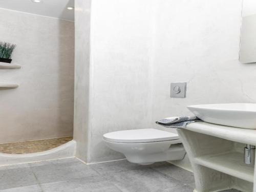 a white bathroom with a toilet and a sink at Premium Naxos Suite Family Suite With Private Balcony Modern Furnishing in Naxos Chora