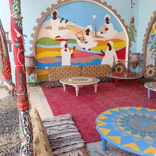 a room with a mural on the side of a building at Hllol Hotel Abu Simbel in Abu Simbel