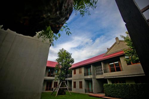 a building with a ladder in front of it at Chu Hotel in Chiang Mai