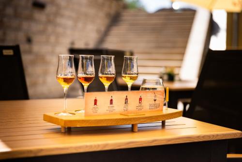 a tray with four wine glasses on a table at Penzion Praděd Thamm in Zlaté Hory