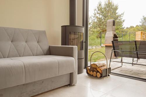 a living room with a couch and a fireplace at Ossona Rest in Częstochowa