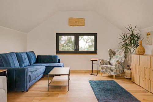 a living room with a blue couch and chairs at Ossona Rest in Częstochowa