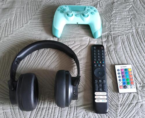 a pair of headphones and a video game controller at Like Home in Saint Lo