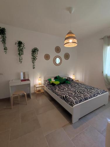 a bedroom with a bed and a table and a lamp at Villa Jana in Porto Pollo