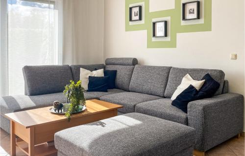 a living room with a couch and a table at Holiday Home Seeblick H in Herzsprung